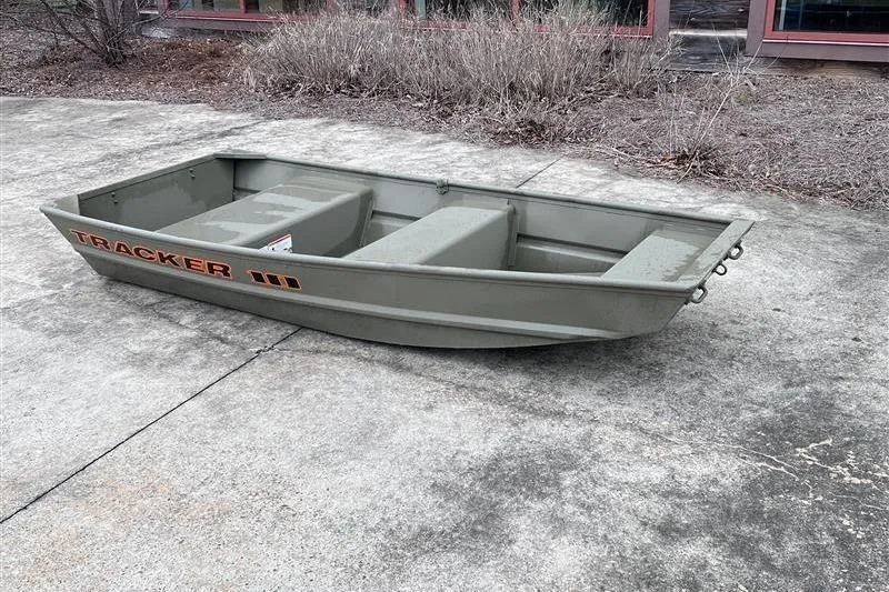 Slide: The Image of 2026 Tracker Grizzly 10 Jon boat on concrete surface, showcasing its compact design. - 4