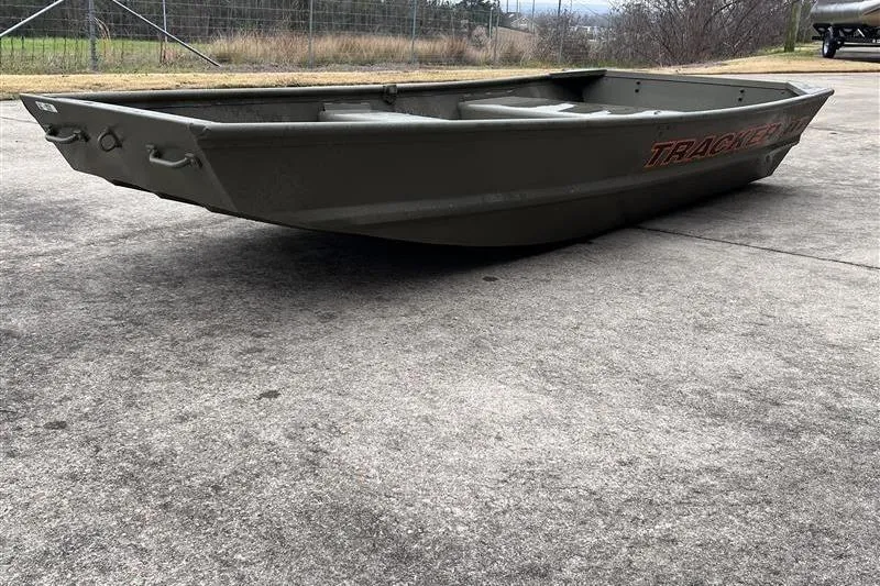 Slide: The Image of 2026 Tracker Grizzly 10 Jon boat on concrete surface, side view. - 5