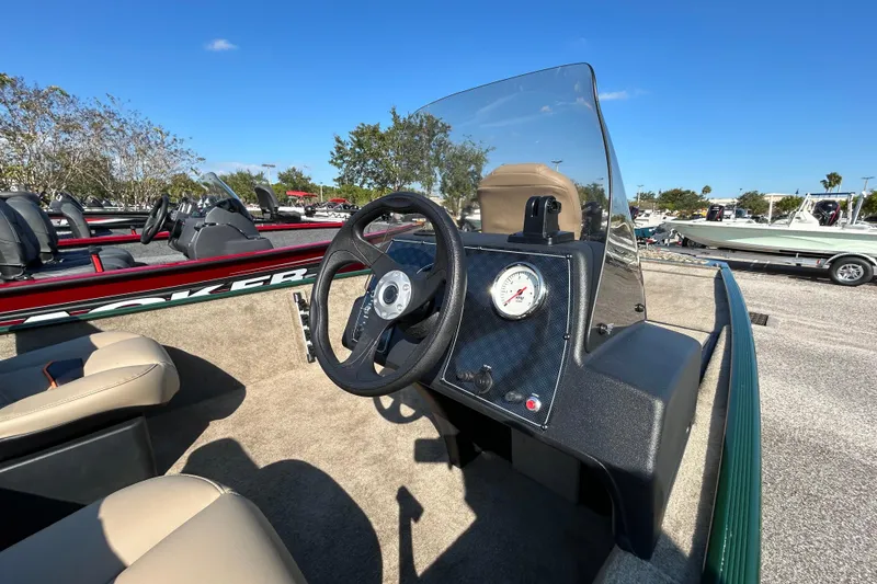 Slide: The Image of 2026 Tracker Bass Tracker Classic Limited boat interior with steering wheel and gauge. - 4
