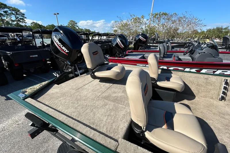 Slide: The Image of 2026 Tracker Bass Tracker Classic Limited boat with Mercury engine, beige seats, and spacious deck. - 5