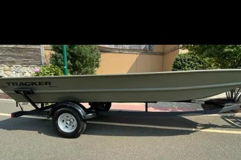The Image of 2026 Tracker Grizzly 1754 Utility boat on trailer, parked outdoors. - 0