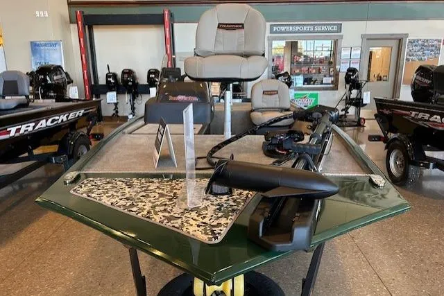 Slide: The Image of 2026 Tracker Bass Tracker Classic Limited boat displayed in showroom with fishing equipment. - 3