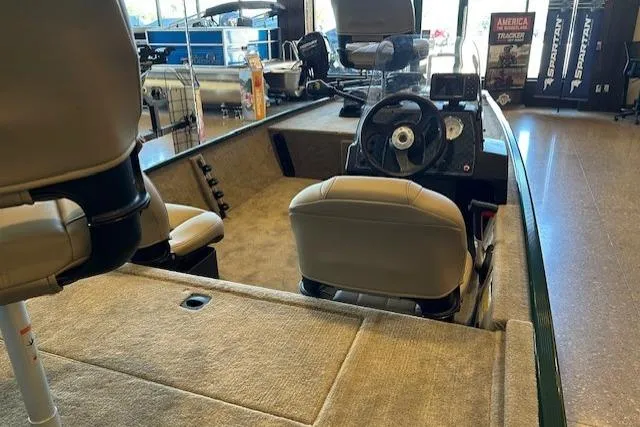 Slide: The Image of 2026 Tracker Bass Tracker Classic Limited boat interior with steering wheel and seating. - 4