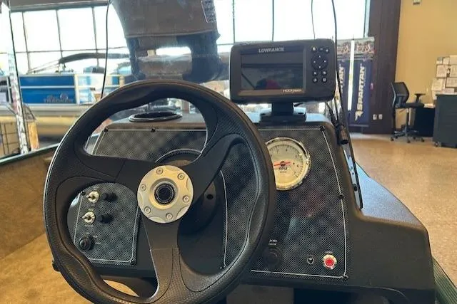 Slide: The Image of 2026 Tracker Bass Tracker Classic Limited dashboard with steering wheel and Lowrance fishfinder. - 5