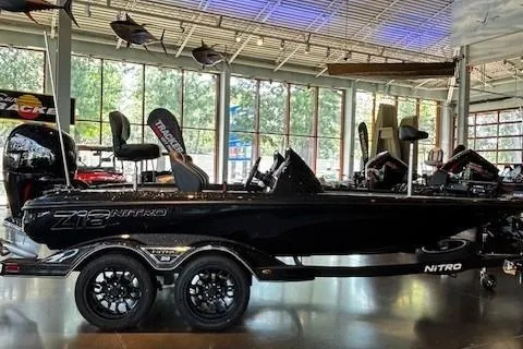 Slide: The Image of 2026 Nitro Z18 Pro boat displayed in a showroom with sleek black design. - 0