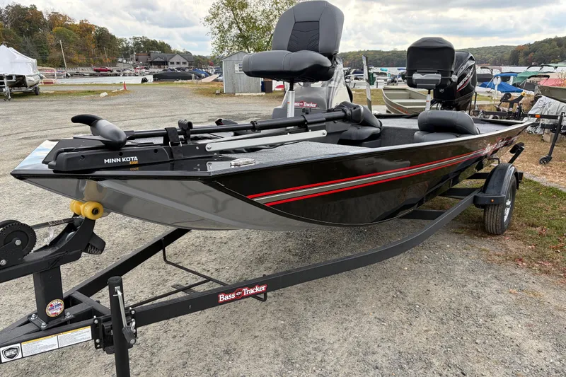 Slide: The Image of 2026 Tracker Bass Tracker Classic XL boat on trailer, parked outdoors. - 61