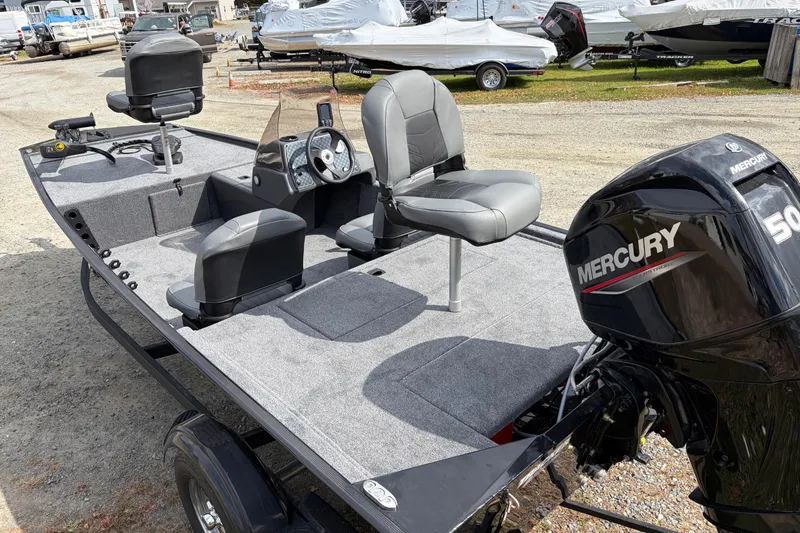 Slide: The Image of 2026 Tracker Bass Tracker Classic XL boat with Mercury engine, featuring comfortable seating and spacious deck. - 67
