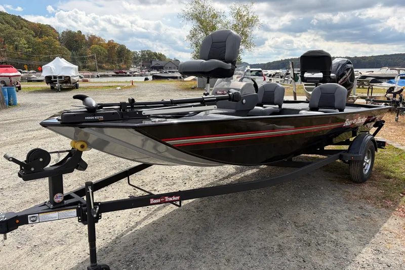 Slide: The Image of 2026 Tracker Bass Tracker Classic XL boat on trailer, parked outdoors under cloudy sky. - 68