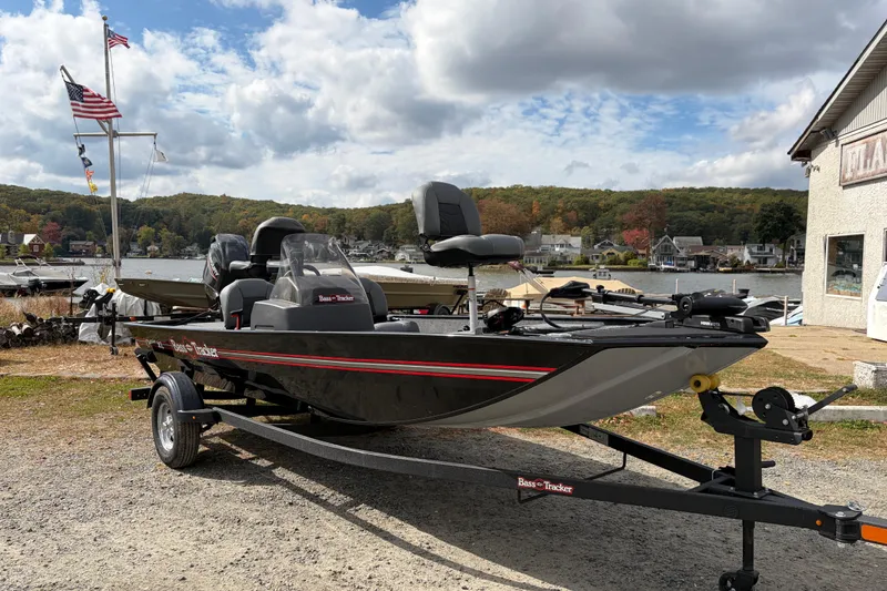 Slide: The Image of 2026 Tracker Bass Tracker Classic XL boat on trailer by a scenic lakeside. - 69
