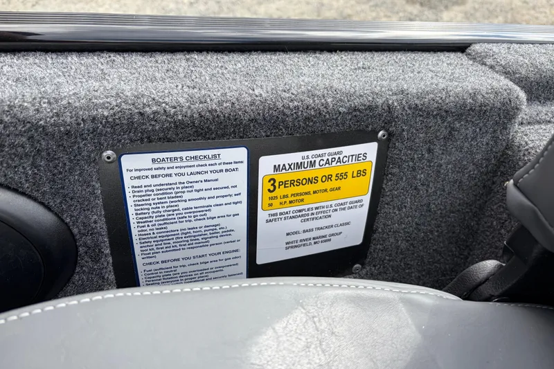 Slide: The Image of 2026 Tracker Bass Tracker Classic XL capacity label and boater's checklist on interior panel. - 70
