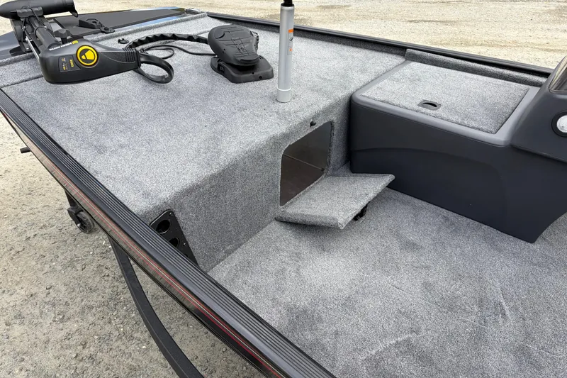 Slide: The Image of 2026 Tracker Bass Tracker Classic XL boat interior with carpeted deck and storage compartment. - 72
