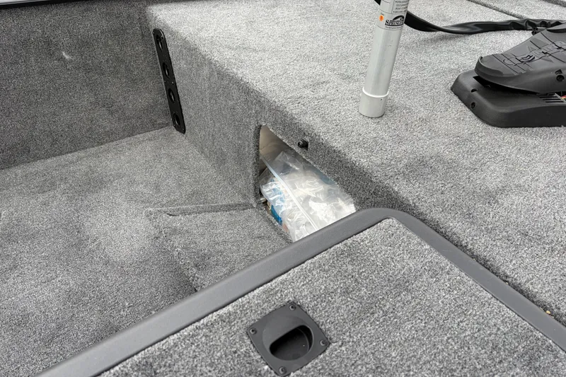 Slide: The Image of 2026 Tracker Bass Tracker Classic XL boat interior with carpeted storage compartment. - 76