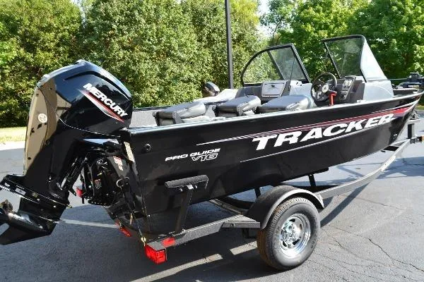 The Image of 2026 Tracker Pro Guide V-16 WT boat on trailer, featuring Mercury outboard motor. - 0