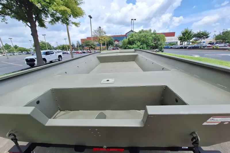 Slide: The Image of 2026 Tracker Grizzly 2072 Utility boat in parking lot, under a partly cloudy sky. - 4