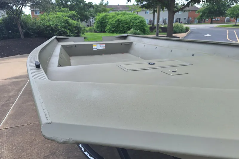 Slide: The Image of 2026 Tracker Grizzly 2072 Utility boat, empty deck, parked outdoors. - 2