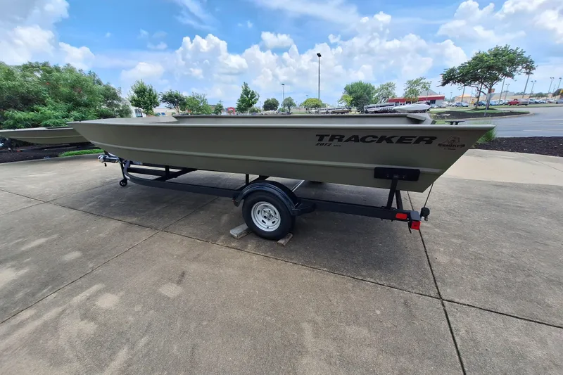 Slide: The Image of 2026 Tracker Grizzly 2072 Utility boat on trailer, parked outdoors under a cloudy sky. - 5