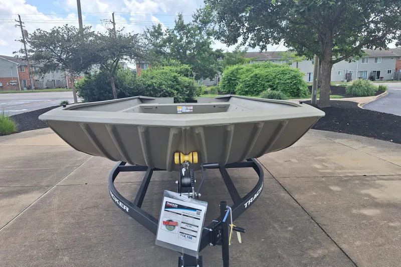 The Image of 2026 Tracker Grizzly 2072 Utility boat on trailer, parked outdoors. - 0