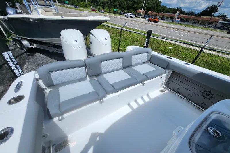 Slide: The Image of 2026 NauticStar 252 Legacy boat interior with cushioned seating and dual engines. - 3