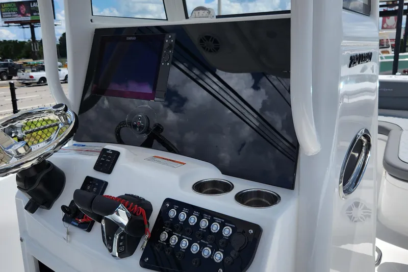 Slide: The Image of 2026 NauticStar 252 Legacy boat dashboard with steering wheel and control panel. - 7