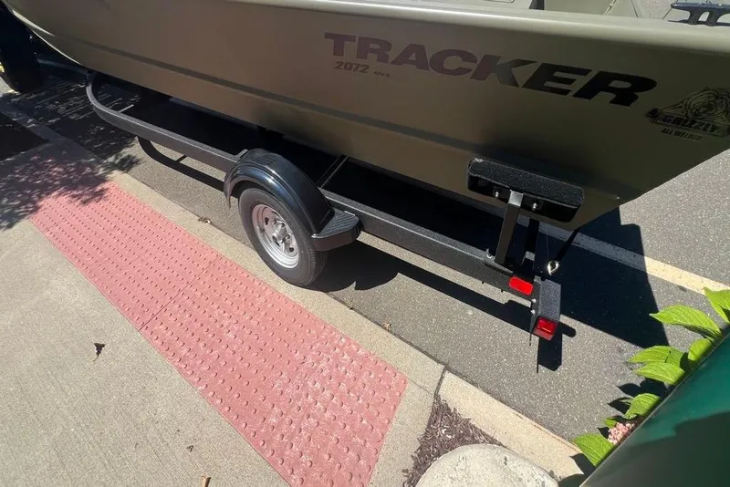 Slide: The Image of 2026 Tracker GRIZZLY 2072 Utility boat on trailer, parked on a street. - 2