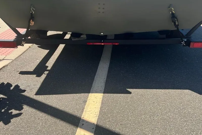 Slide: The Image of Rear view of 2026 Tracker GRIZZLY 2072 Utility trailer on a road. - 3