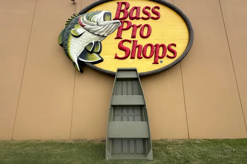The Image of Bass Pro Shops sign with 2026 Tracker Grizzly 10 Jon boat displayed below. - 0