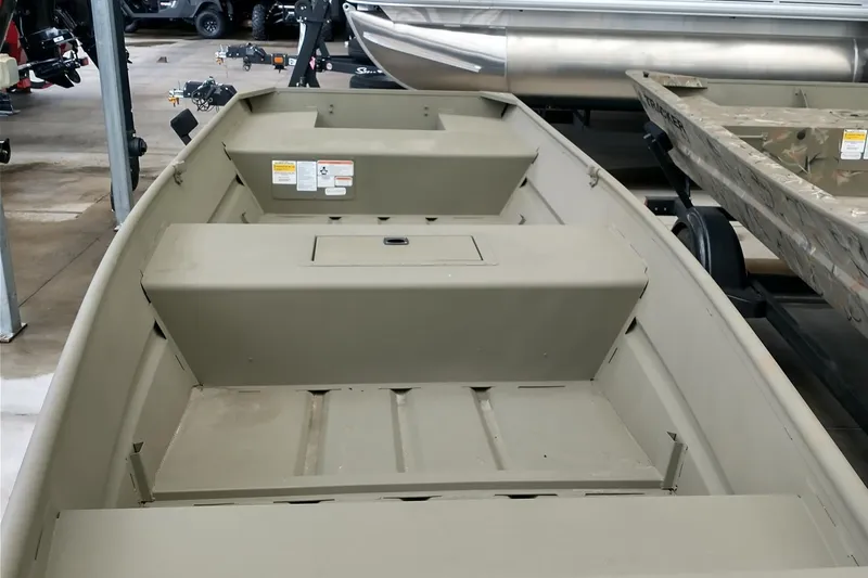Slide: The Image of 2026 Tracker Grizzly 15 Jon boat interior, showcasing seating and storage compartments. - 2