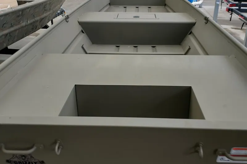 Slide: The Image of 2026 Tracker Grizzly 15 Jon boat interior, showcasing seating and storage compartments. - 4