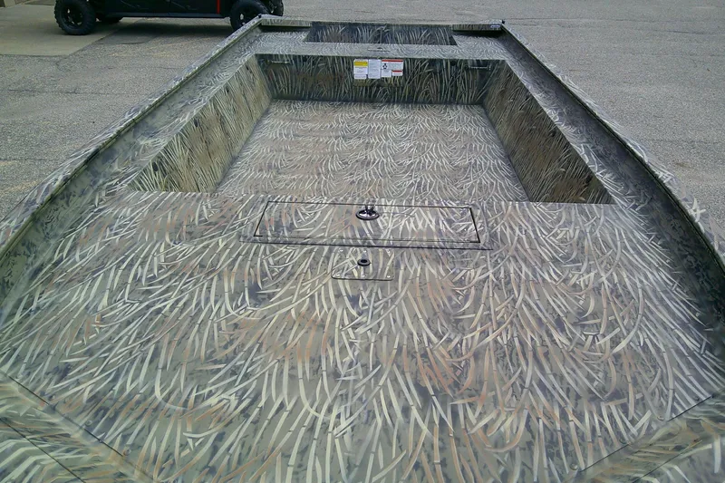 Slide: The Image of 2026 Tracker Grizzly 1860 Utility boat with camouflage interior design. - 2