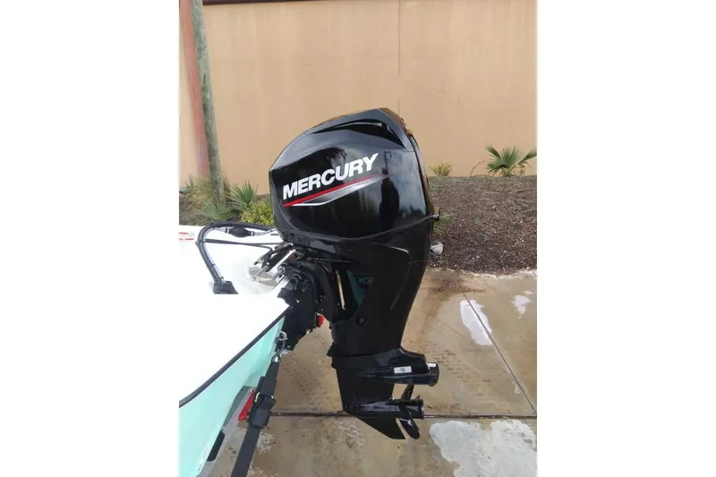 Slide: The Image of 2026 Mako Pro Skiff 15 CC with Mercury outboard motor, parked outdoors. - 61