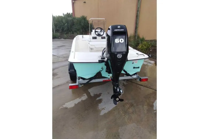 Slide: The Image of 2026 Mako Pro Skiff 15 CC with Mercury 60 outboard motor on trailer. - 62
