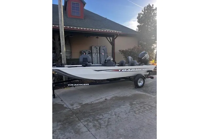 Slide: The Image of 2026 Tracker Pro 170 boat parked outdoors on a driveway. - 65