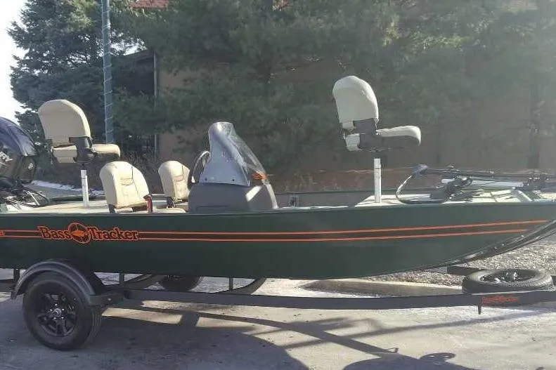 The Image of 2026 Tracker Bass Tracker Classic Limited boat on trailer, parked outdoors. - 0