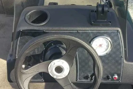 Slide: The Image of 2026 Tracker Bass Tracker Classic Limited dashboard with steering wheel and gauge. - 2