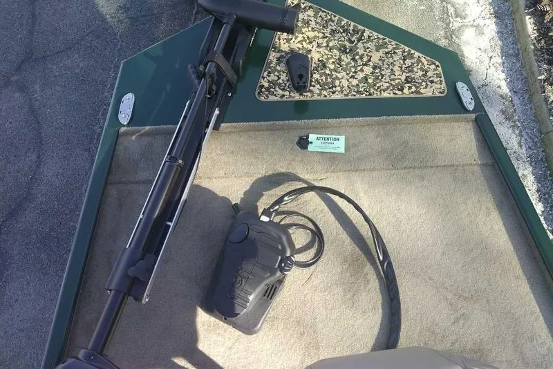 Slide: The Image of 2026 Tracker Bass Tracker Classic Limited boat deck with trolling motor and camouflage panel. - 3