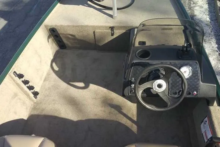 Slide: The Image of 2026 Tracker Bass Tracker Classic Limited boat interior with steering wheel and dashboard. - 4