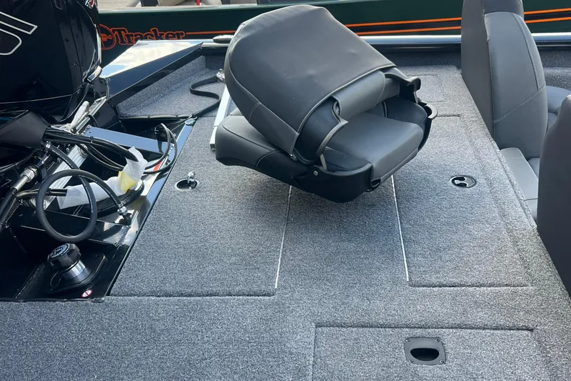 Slide: The Image of 2026 Tracker Pro Team 190 boat interior with folded seat and motor. - 7