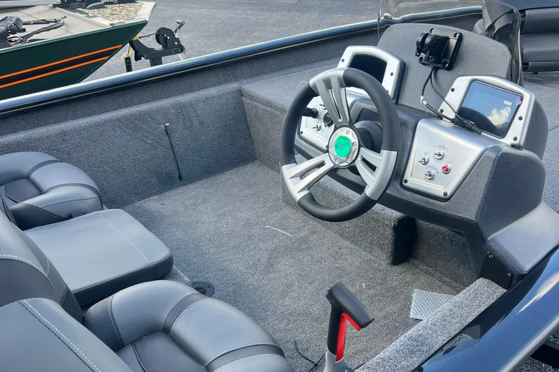 Slide: The Image of 2026 Tracker Pro Team 190 boat interior with steering wheel and control panel. - 8