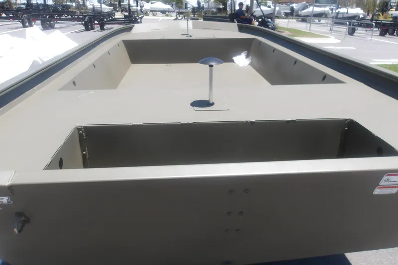 Slide: The Image of 2026 Tracker Grizzly 1860 Utility boat, spacious interior, displayed outdoors. - 17