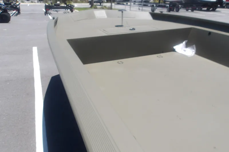 Slide: The Image of 2026 Tracker Grizzly 1860 Utility boat in a parking lot, showcasing its spacious deck. - 21