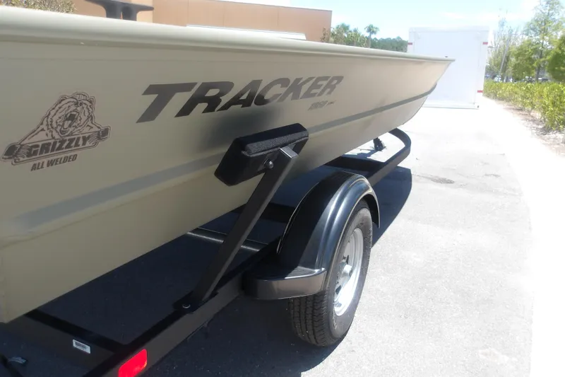 Slide: The Image of 2026 Tracker Grizzly 1860 Utility boat on trailer, showcasing all-welded design. - 3