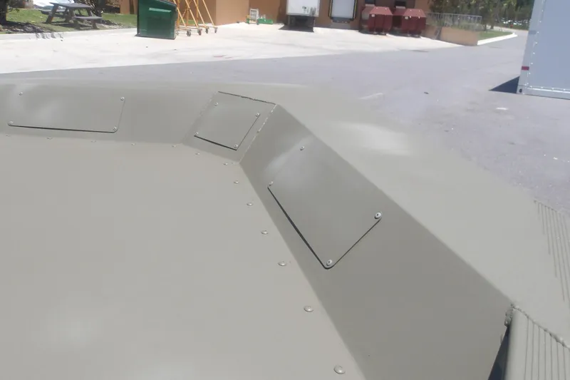 Slide: The Image of 2026 Tracker Grizzly 1860 Utility boat deck, showcasing riveted metal panels in an outdoor setting. - 7
