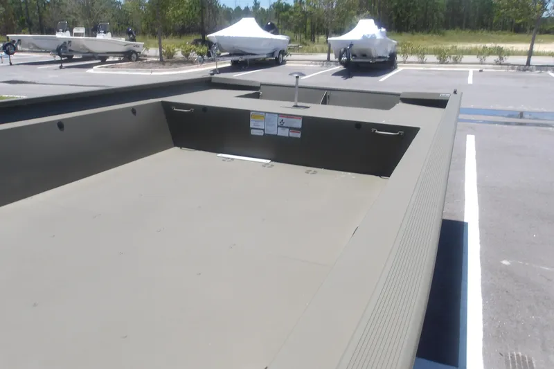 Slide: The Image of 2026 Tracker Grizzly 1860 Utility boat in parking lot, showcasing spacious interior design. - 16