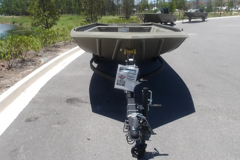 Slide: The Image of 2026 Tracker Grizzly 1860 Utility boat on trailer in outdoor setting. - 13
