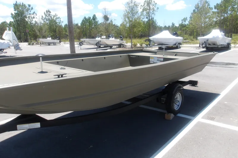 Slide: The Image of 2026 Tracker Grizzly 1860 Utility boat on trailer in parking lot. - 15