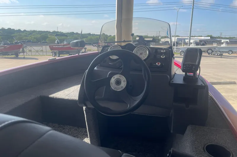Slide: The Image of Interior view of 2026 Tracker Super Guide V-16 SC boat with steering wheel and dashboard. - 7