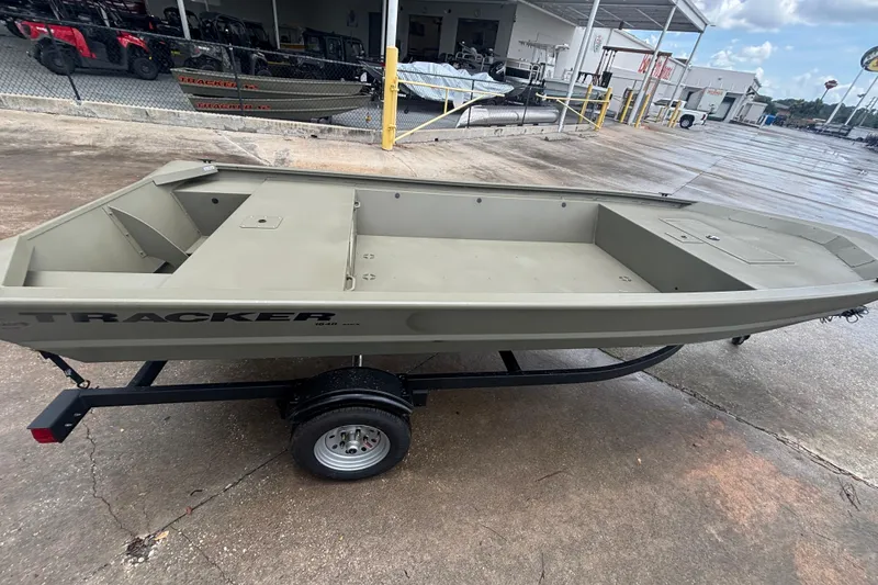 The Image of 2026 Tracker Grizzly 1648 Utility boat on trailer, parked outdoors. - 0