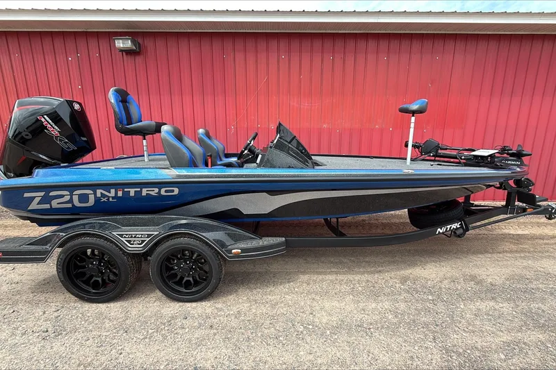 The Image of 2026 Nitro Z20 XL Pro boat with blue accents, parked on a trailer. - 0