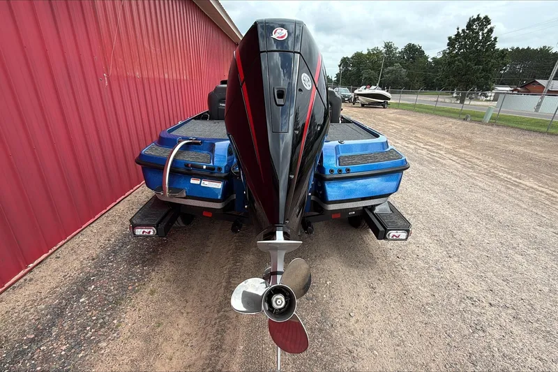 Slide: The Image of 2026 Nitro Z20 XL Pro boat with powerful outboard motor, parked on gravel. - 1