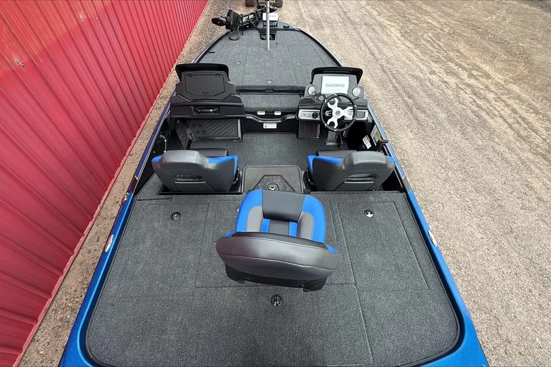 Slide: The Image of 2026 Nitro Z20 XL Pro boat interior with Garmin system, blue and black seating, and spacious deck. - 2